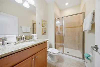 a bathroom with a shower and a toilet and a sink at Cozy Home Luxury 04 Bedrooms At Storey Lake in Kissimmee