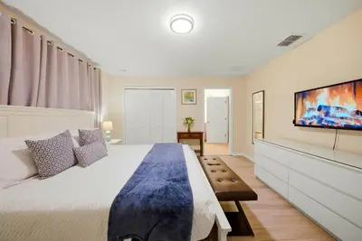 a bedroom with a large bed and a flat screen tv at Cozy Home Luxury 04 Bedrooms At Storey Lake in Kissimmee