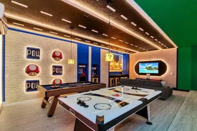 a room with a ping pong table and a tv at Luxurious 15-Bedroom Villa With Pool & Games Room in Kissimmee
