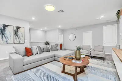 a living room with a couch and a table at Luxurious 15-Bedroom Villa With Pool & Games Room in Kissimmee