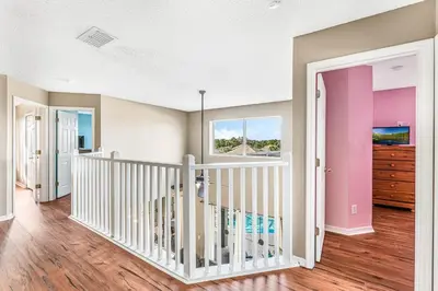 a room with a crib and a window at Luxury 8-Bed Villa Near Disney With Pool & More in Kissimmee