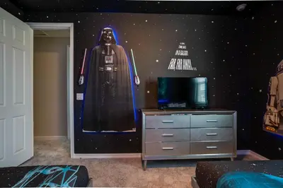 a bedroom with a star wars mural on the wall at Ev1810 - Solara Galaxy Villa in Orlando