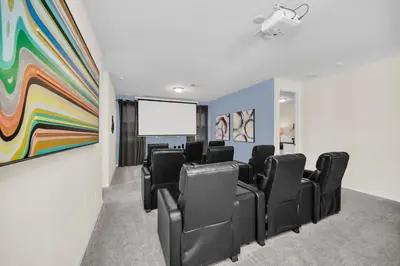 a conference room with black chairs and a projection screen at Ev1810 - Solara Galaxy Villa in Orlando