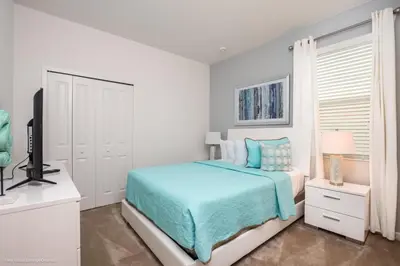 a white bedroom with a bed and a television at Ev2619 - Sonoma Retreat in Kissimmee