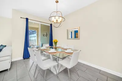 a dining room with a table and chairs at Ev4829 - Lullaby Oasis in Kissimmee