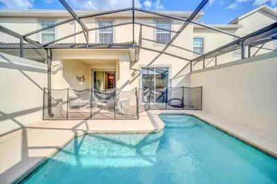 a swimming pool in front of a building at Ev4829 - Lullaby Oasis in Kissimmee