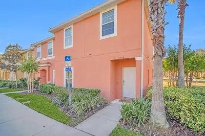 a orange building with a street sign in front of it at Ev30360 - Encantada Villa in Kissimmee