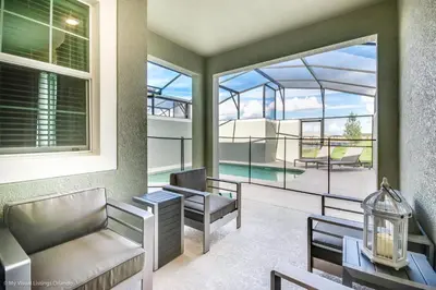 a living room with a view of a pool at Ev4958 - Sunset Cove Villa in Kissimmee