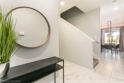 a hallway with a large mirror and a table at Ev4958 - Sunset Cove Villa in Kissimmee