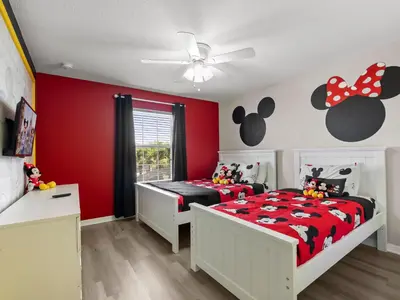 a bedroom with a bed with a black and red blanket at Ev4891 - Harmony Haven Retreat in Kissimmee