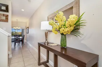 a vase of yellow flowers on a table in a hallway at Ev8944 - Paradise Palms Escape in Kissimmee