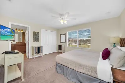 a bedroom with a bed and a desk and a window at Ev8940 - Magic Palms Retreat in Kissimmee