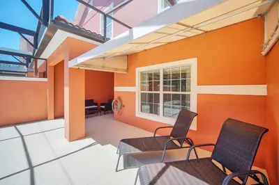 a room with two chairs and a table and a window at Ev8940 - Magic Palms Retreat in Kissimmee