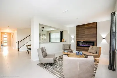 a living room with two chairs and a table at Ev9043 - Solara Prestige Villa in Orlando