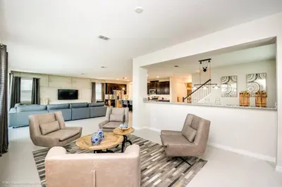 a living room with two chairs and a table at Ev9043 - Solara Prestige Villa in Orlando