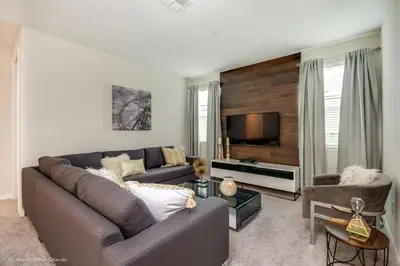 a living room with a couch and a flat screen tv at Ev9043 - Solara Prestige Villa in Orlando