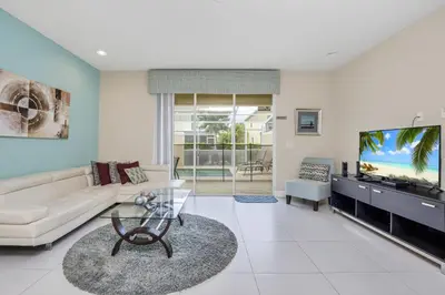 a living room with a couch and a flat screen tv at Ev1445 - The Palm Retreat in Orlando