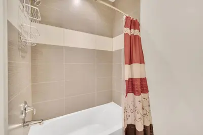 a shower with a red and white shower curtain at Ev1447 - The Retreat Villa in Orlando
