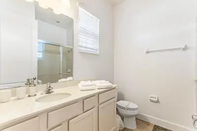 a white bathroom with a sink and a toilet at Ev1472 - Reunion Getaway in Orlando