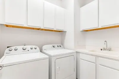 a white kitchen with white cabinets and white appliances at Ev1472 - Reunion Getaway in Orlando