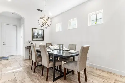 a dining room with a black table and chairs at Ev1472 - Reunion Getaway in Orlando