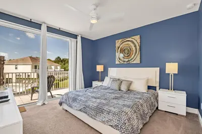 a blue bedroom with a bed and a balcony at Ev1511 - The Serenity Villa in Orlando