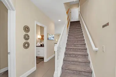 a staircase in a home with white walls at Ev1511 - The Serenity Villa in Orlando