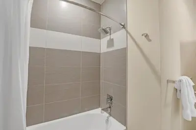 a bathroom with a shower with a tub and a sink at Ev1511 - The Serenity Villa in Orlando