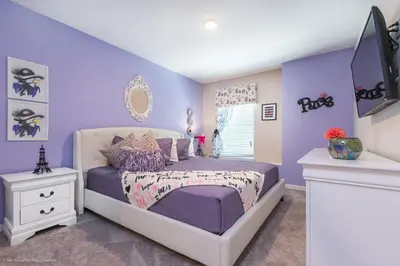 a bedroom with purple walls and a white bed at Ev1542 - Solara Luxe in Orlando