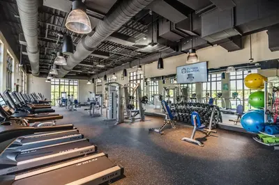 a gym with rows of exercise bikes and treadmills at Ev1542 - Solara Luxe in Orlando