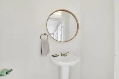 a bathroom with a white sink and a mirror at Ev2010 - Windsor Star Retreat in Kissimmee