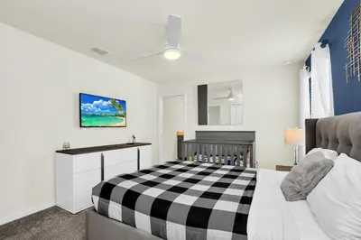 a bedroom with a black and white checkered bed at Ev2010 - Windsor Star Retreat in Kissimmee