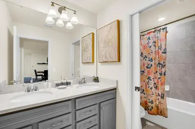 a bathroom with two sinks and a tub and a shower at Ev2010 - Windsor Star Retreat in Kissimmee