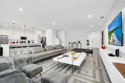 a living room with a couch and a table at Ev2395 - Grand Haven Retreat in Kissimmee