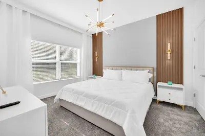 a white bedroom with a white bed and a window at Ev2444 - Palm Breeze Escape in Kissimmee