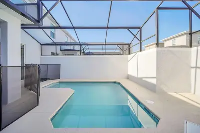 an indoor swimming pool in a building with glass ceilings at Ev2444 - Palm Breeze Escape in Kissimmee