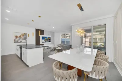a kitchen and dining room with a white table and chairs at Ev2444 - Palm Breeze Escape in Kissimmee
