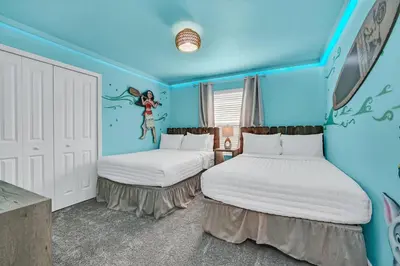 two beds in a room with blue walls at Ev2529 - Grand Orchid Retreat in Kissimmee