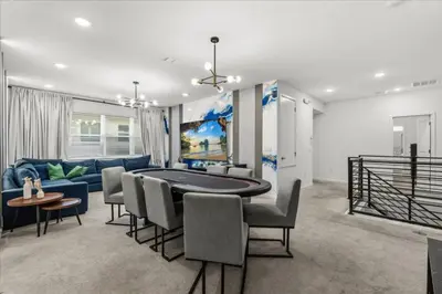 a living room with a table and a blue couch at 2558Shanti in Kissimmee