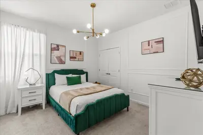 a bedroom with a green bed and a desk at 2558Shanti in Kissimmee