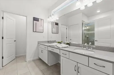 a white bathroom with a sink and a mirror at 2558Shanti in Kissimmee