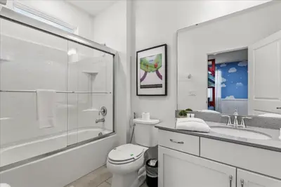 a bathroom with a toilet and a shower and a sink at 2558Shanti in Kissimmee