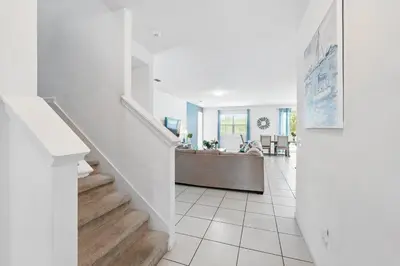 a white hallway with a staircase in a house at Ev2576 - Lakeside Adventure Villa in Kissimmee