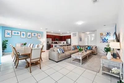 a living room with a couch and a table at Ev2576 - Lakeside Adventure Villa in Kissimmee