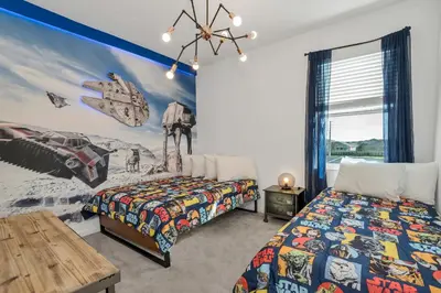 a bedroom with two beds and a table at Ev2613 - Grand Horizon Manor in Kissimmee