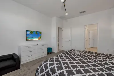 a bedroom with a bed and a tv on the wall at Ev2613 - Grand Horizon Manor in Kissimmee