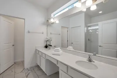 a white bathroom with two sinks and a large mirror at Ev2613 - Grand Horizon Manor in Kissimmee