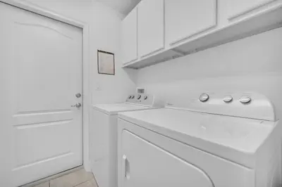 a white kitchen with a stove and a dishwasher at Ev2628 - Veranda Palms Hideaway in Kissimmee