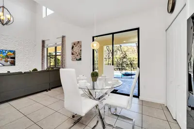 a dining room with a glass table and white chairs at Ev2628 - Veranda Palms Hideaway in Kissimmee