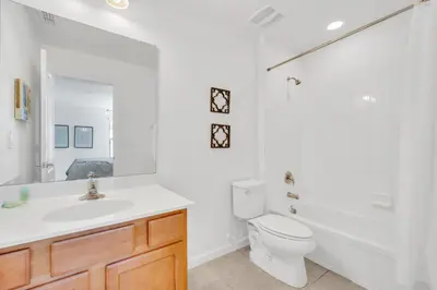 a white bathroom with a sink and a toilet at Ev2628 - Veranda Palms Hideaway in Kissimmee